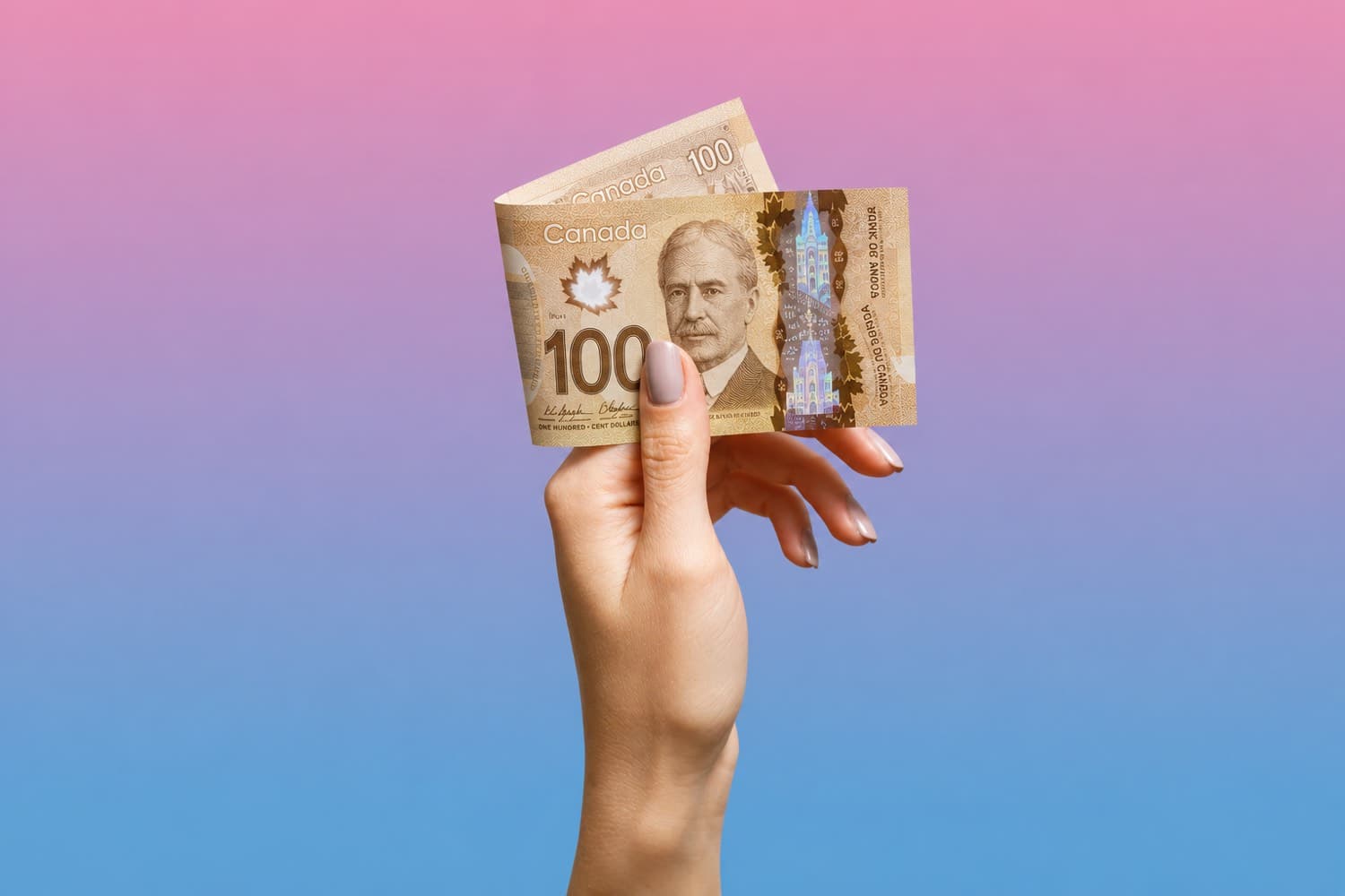 Hand holding a Canadian banknote