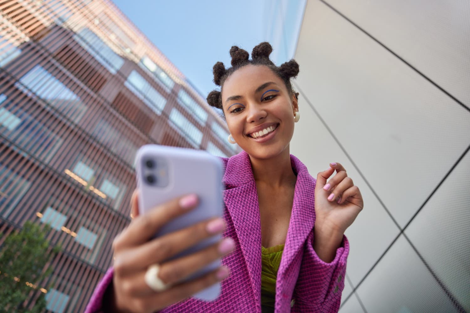 A small business owner smiling at their phone